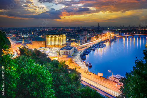 Picturesque evening landscape of the Postal Square, the river station and the Dnieper River in the capital of Ukraine, the city of Kyiv. Skyline of Podil and Obolon at night in Kiev