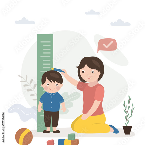 Cute mother measures height of her son on height meter. European family, mom and little boy. Childhood, health care. Funny cartoon characters. Measurement process.