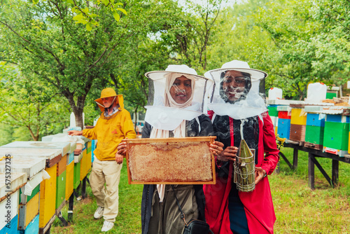 Arab investors checking the quality and production of honey on a large honey farm. 