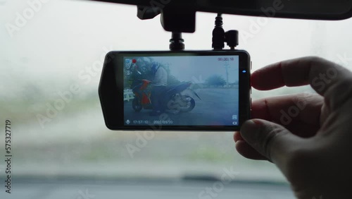 Smart driver checking video recorder in the car before driving, dash cam digital for safety road in traffic accident, Cam front windshield record traffic ahead and navigation.