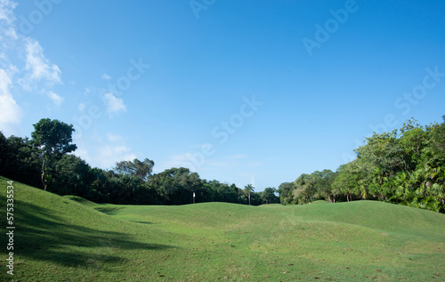 Fototapeta Naklejka Na Ścianę i Meble -  Golf in harmony with nature on a course nestled in the tropical forest against the blue sky in Mexico