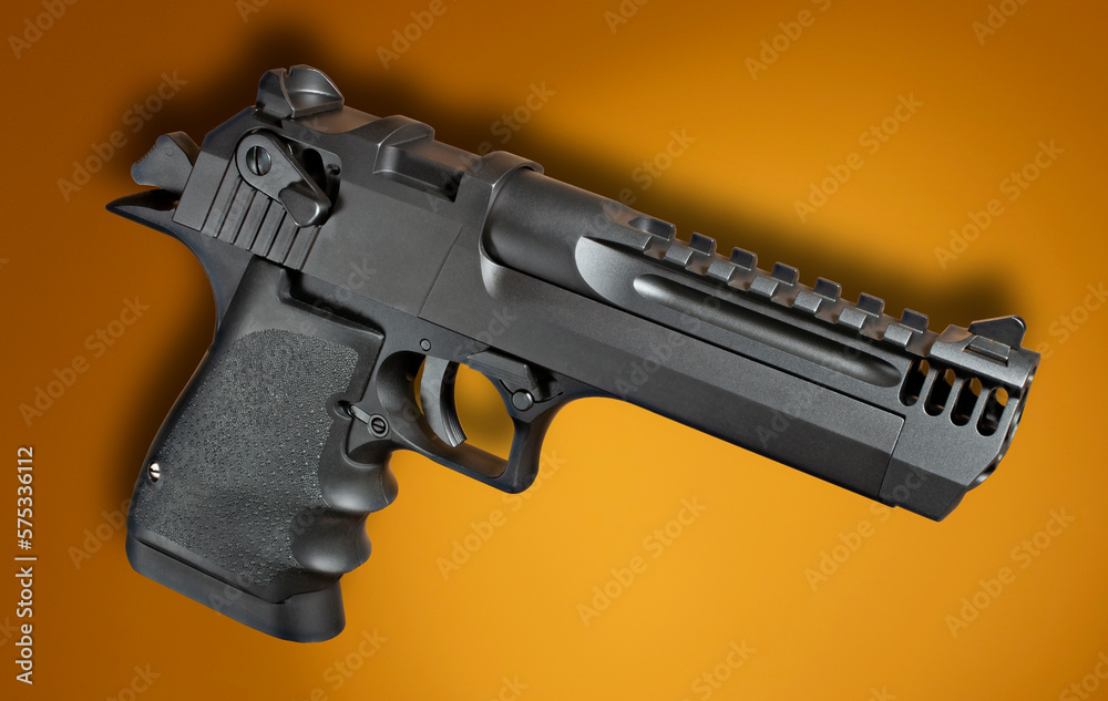 Semi auto pistol on orange with shadow Semi auto pistol on orange with shadow