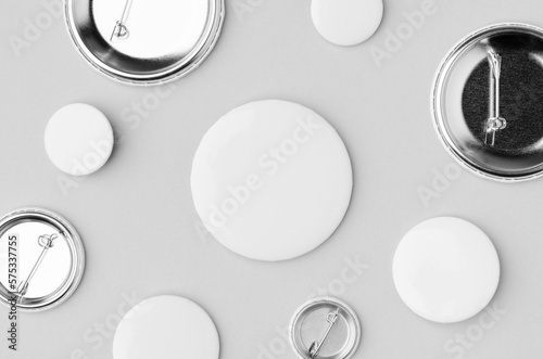 Multiple different sized badges  on a grey background. photo