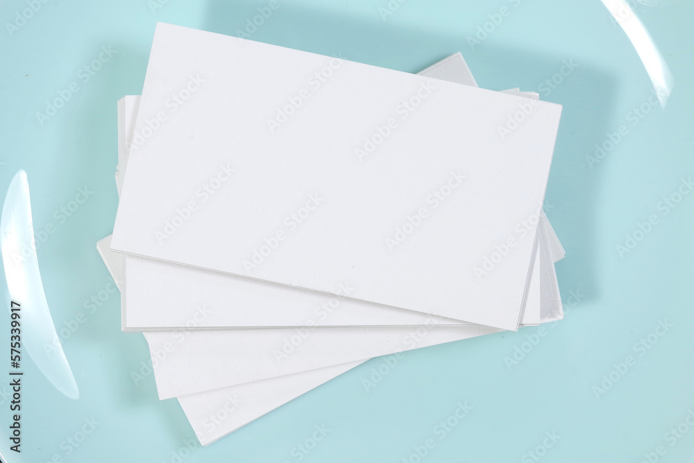 Blank white mock-up business cards, porcelain blue plate on dark backgound table