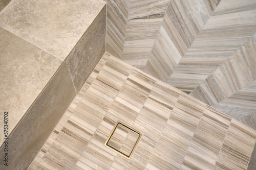 Detail of tile wall, bench and floor in a contemporary shower