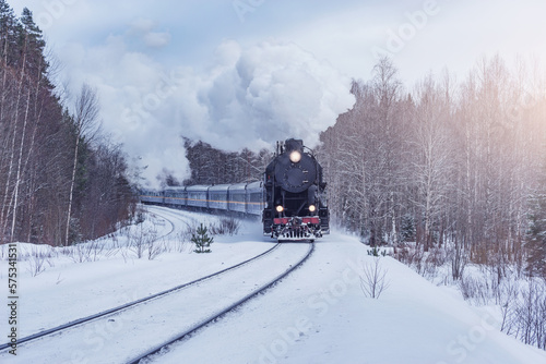 Retro steam train moves at winter day. © serjiob74