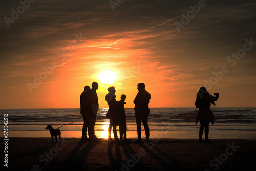 Sunset, hapiness, sweet memories, family at the beach enjoying the sunset, coast, northsea, evening, julianadorp, Netherlands. photo