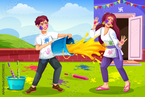 Cheerful Indian people celebrate the color festival of India, Holi full of happiness. Boy hand splashing color from bucket to girl. Holi is a spring-summer festival. Holi party celebration concept.