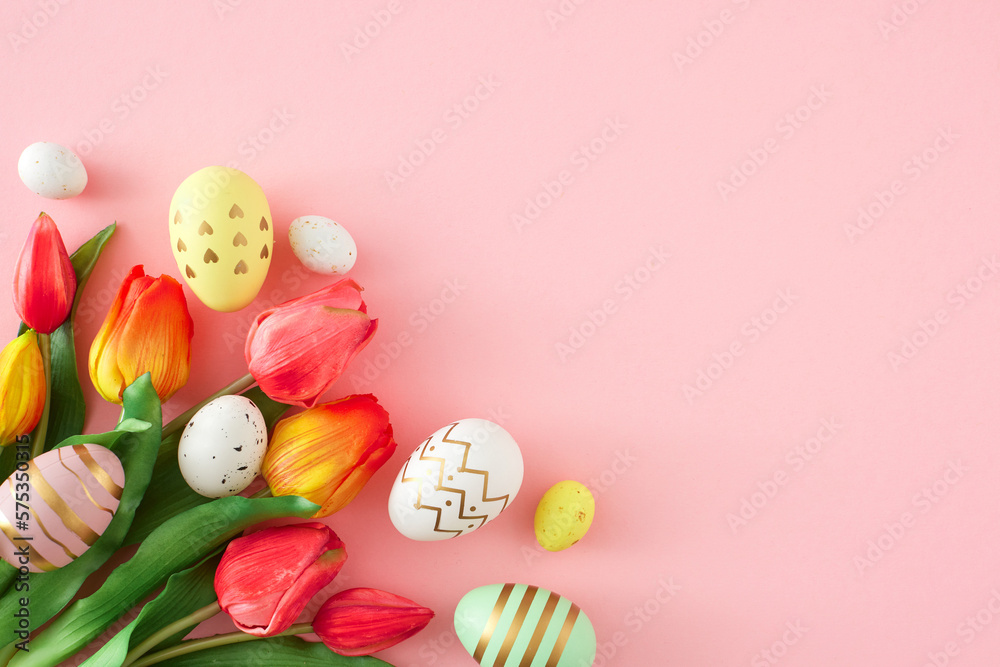 Easter concept. Flat lay photo of bouquet tulips flowers colorful eggs on isolated pastel pink background with copyspace. Holiday card idea