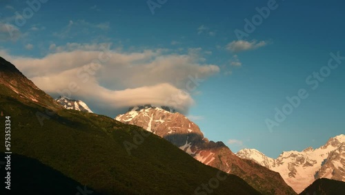 Clouds over the mountains at sunrise timelapse. Clouds forming and moving over the mountains. Summer landscape. Digor Gorge in North Ossetia, Caucasus, Russia.
 photo