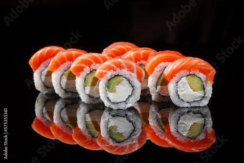 Philadelphia sushi rolls on black background 