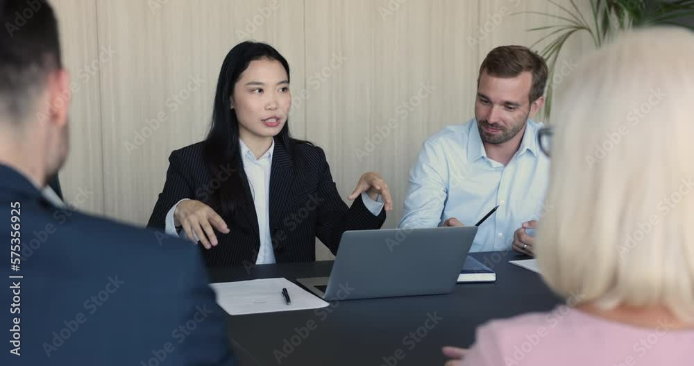 Young, ambitious team negotiate meet in company office boardroom, Asian businesswoman, share information, convinces to company clients, make speech, discuss commercial deal, take part in group meeting Young, ambitious team negotiate meet in company office boardroom, Asian businesswoman, share information, convinces to company clients, make speech, discuss commercial deal, take part in group meeting