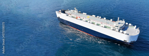 Aerial drone ultra wide panoramic photo of huge car carrier ship RO-RO (Roll on Roll off) cruising in Mediterranean deep blue Aegean sea © aerial-drone