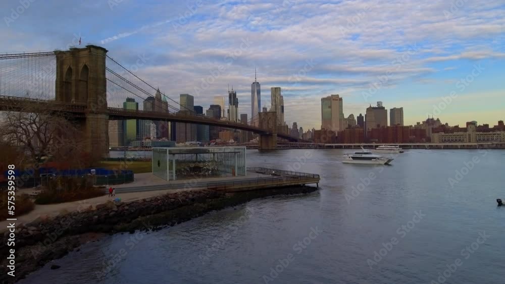 Aerial Forward Shot Of Cruise Ships Moving On East River Over Brooklyn Bridge In City - New York, New York Aerial Forward Shot Of Cruise Ships Moving On East River Over Brooklyn Bridge In City - New York, New York