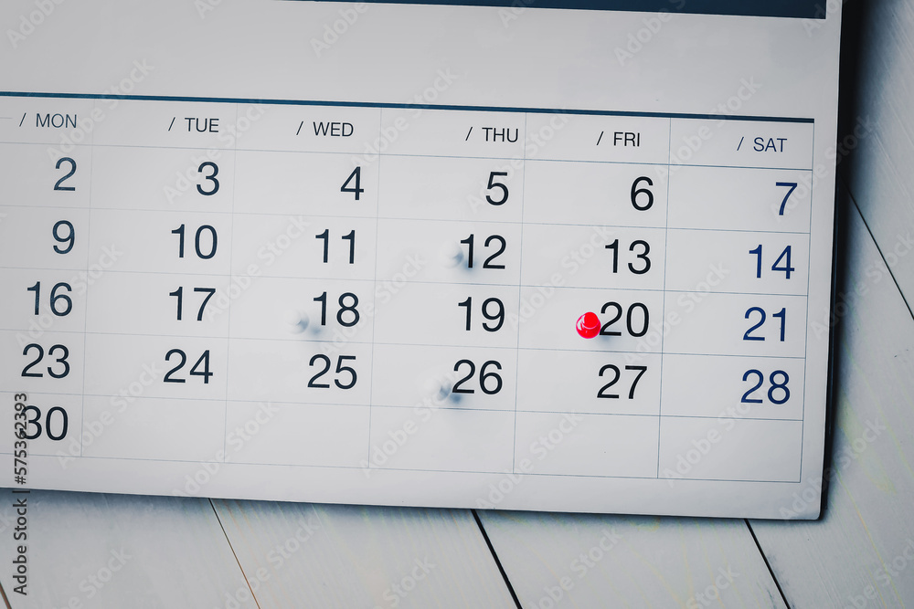 Embroidered red pins on a calendar event Planner calendar,clock to set timetable organize schedule,planning for business meeting or travel planning concept. Embroidered red pins on a calendar event Planner calendar,clock to set timetable organize schedule,planning for business meeting or travel planning concept.