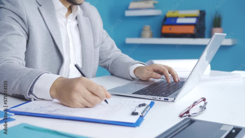 Close-up of young businessman working in office.
Successful young businessman typing on keyboard on laptop, taking notes.
Close-up of young businessman working in office.
Successful young businessman typing on keyboard on laptop, taking notes.