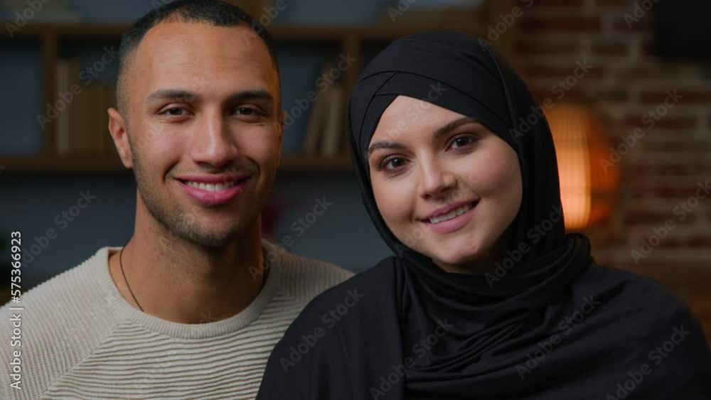 Spouses family multiracial diverse ethnicity couple man african american husband and arabian muslim woman wife in hijab smiling multiethnic girlfriend boyfriend in love 30s happy homeowners portrait Spouses family multiracial diverse ethnicity couple man african american husband and arabian muslim woman wife in hijab smiling multiethnic girlfriend boyfriend in love 30s happy homeowners portrait
