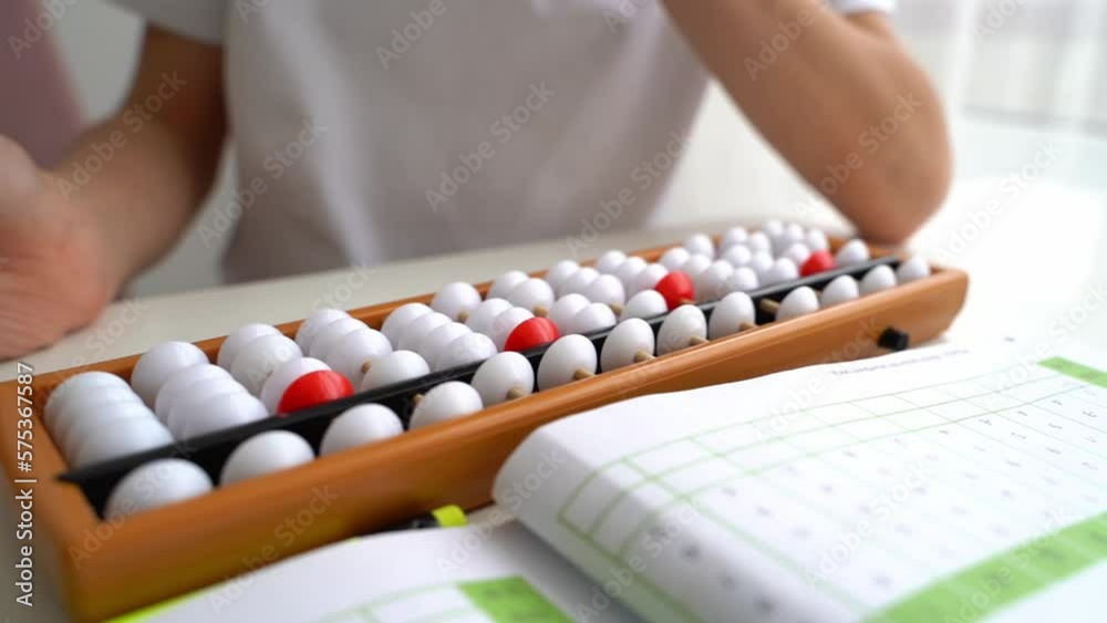 The boy is engaged in abacus, mental arithmetic for children The boy is engaged in abacus, mental arithmetic for children