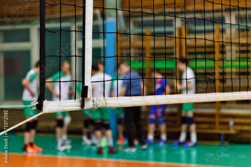 Coach analyze game of volleyball team during timeout in school sport old gym. Background for team volleyball games. Concept of getting sport, healthy lifestyle and team success. Copy ad text space