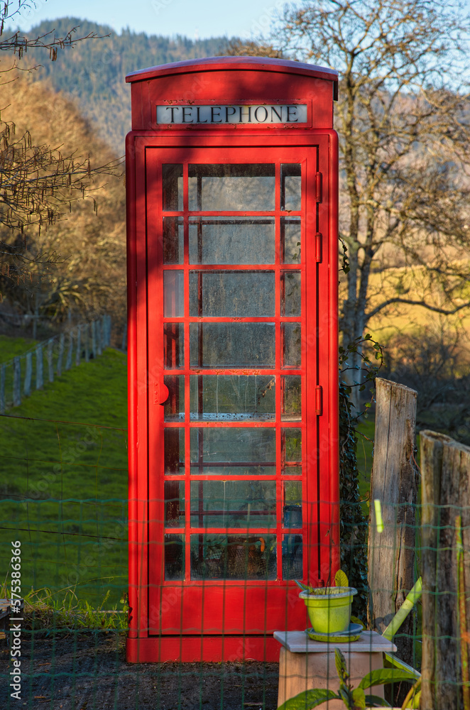 A traditional english red phone booth in Candaneu village, Pilona, Asturias, Spain A traditional english red phone booth in Candaneu village, Pilona, Asturias, Spain