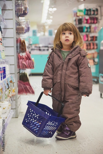 charming child shopping in a supermarket in Denmark