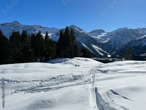 Wonderful winter hiking trails and traces in the fresh alpine snow cover of the Swiss Alps and over the tourist resort of Arosa - Canton of Grisons, Switzerland (Schweiz)