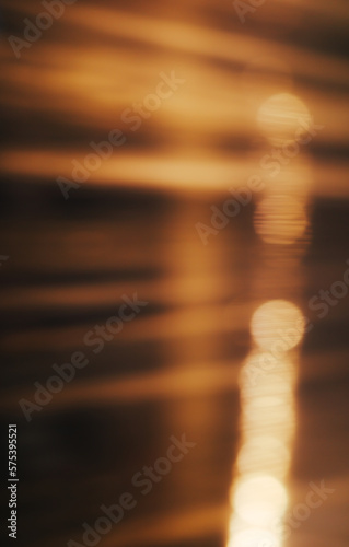 Abstract background with bokeh defocused warm lights from electricity post on street through a window at night. 