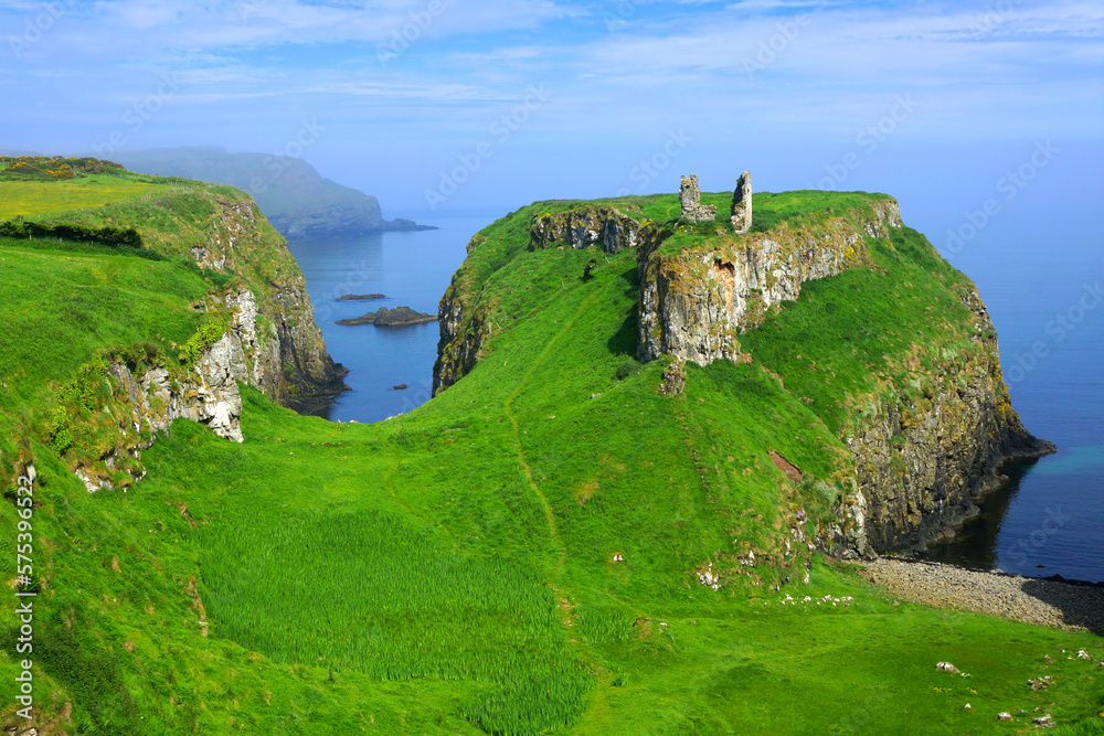 Ruins of the ancient Dunseverick Castle atop the green cliffs of the Causeway Coast, Northern Ireland