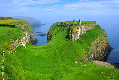 Ruins of the ancient Dunseverick Castle atop the green cliffs of the Causeway Coast, Northern Ireland