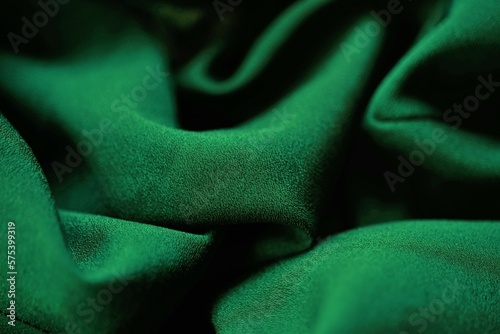Delicate dark green fabric, green material chiffon waves