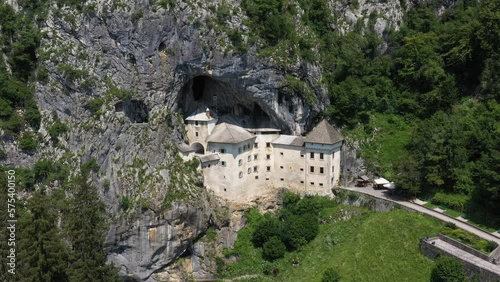 Predjama Castle in Slovenia, Europe. Renaissance castle built within a cave mouth in south central Slovenia, in the historical region of Inner Carniola. It is located in the village of Predjama. Drone photo