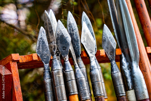 Iron spearheads of various shapes with wooden handles photo