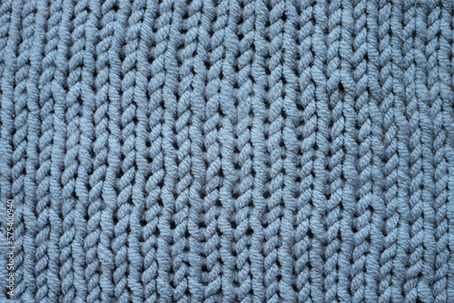 Knitted grey background, gray sweater cozy pattern