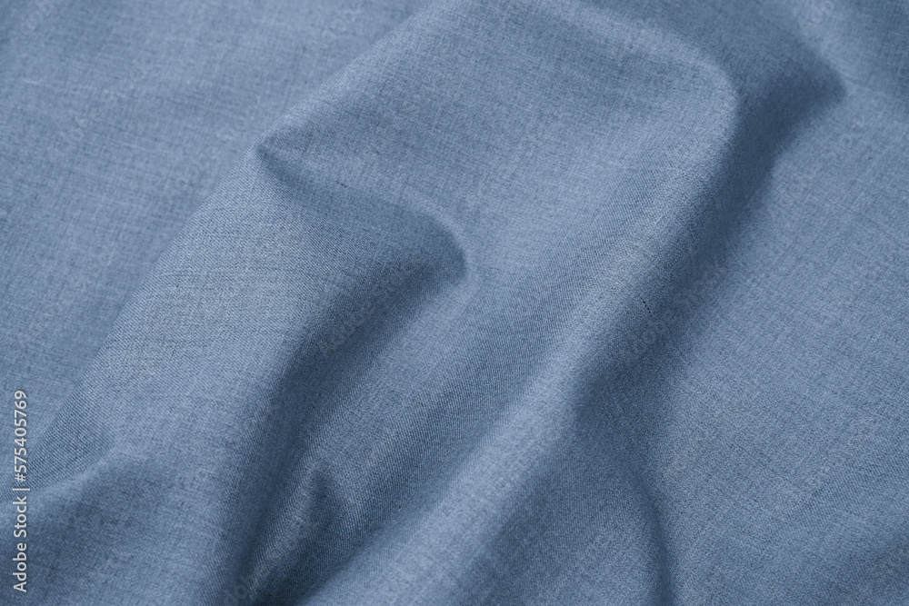 Close-up of plain silver grey blue fabric cloth texture. Abstract background of monochromatic textile material and texture for design. Copy space.