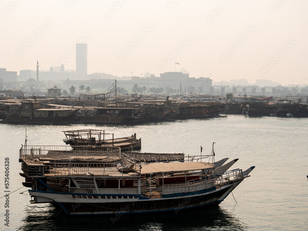 Obraz premium Misty view of boats in the bay in the city of Doha, capital of Qatar