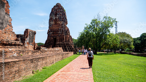 tourist walks in ruins of Wat Mahathat in Ayutthaya, Thailand