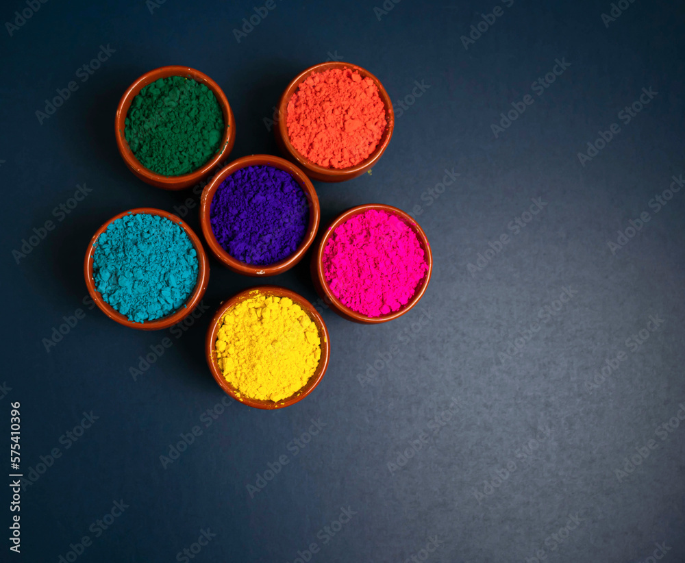 top view of colorful traditional holi powder in bowls isolated on white background.Space for text . happy holi.Concept Indian color festival called Holi top view of colorful traditional holi powder in bowls isolated on white background.Space for text . happy holi.Concept Indian color festival called Holi
