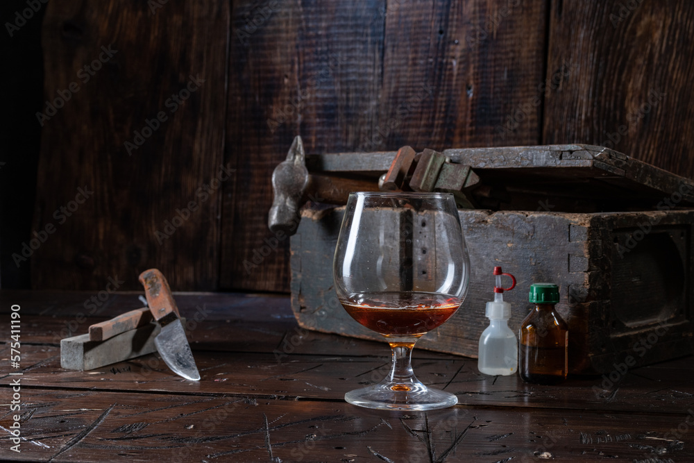 Half empty glass. Cognac glass half empty. Cognac glass in the workshop