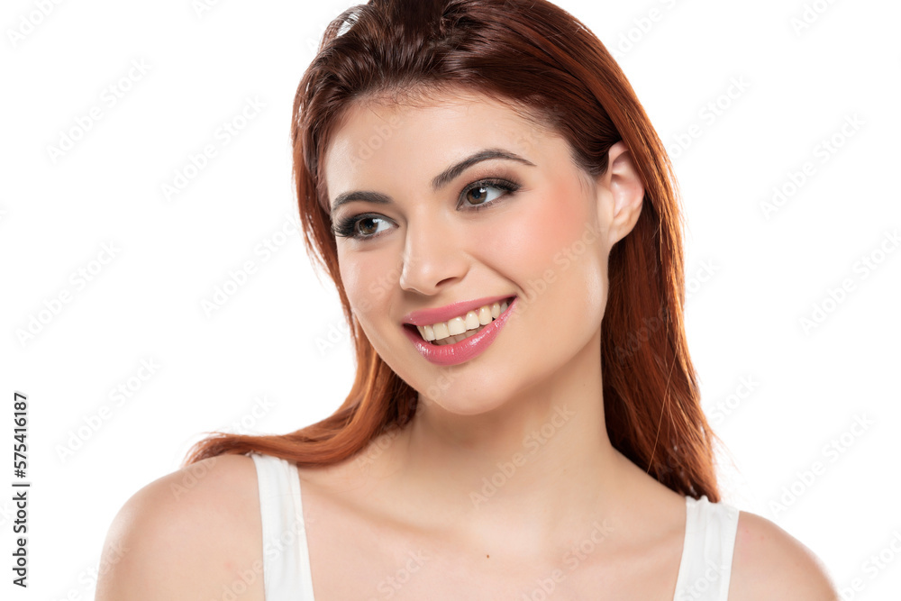 beautiful young smiling redhead women with makeup and long hair on a white background. beautiful young smiling redhead women with makeup and long hair on a white background.