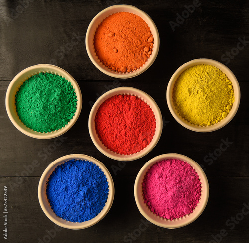 Wallpaper Mural top view of colorful traditional holi powder in bowls isolated on dark background.Space for text . happy holi.Concept Indian color festival called Holi Torontodigital.ca