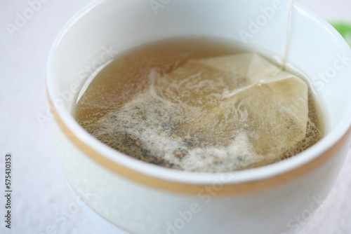 green tea and tea bag on table  close up.