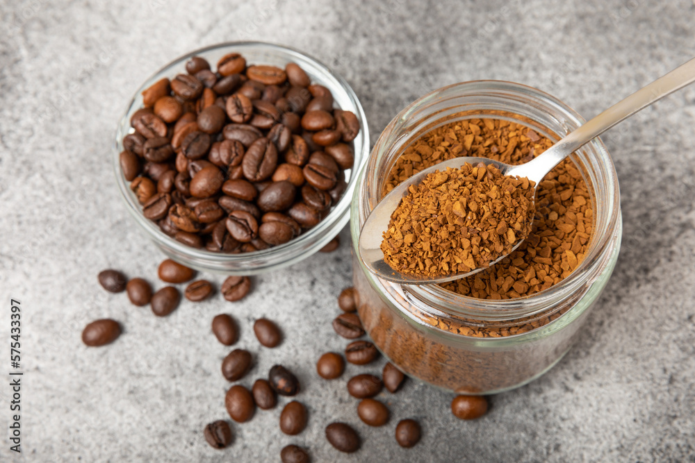 Ingredients for making coffee - coffee beans, ground and instant coffee on a black textured background. Caffeine. Decaffeinated coffee. Aroma energy hot drink. Place for text, space for copy. Ingredients for making coffee - coffee beans, ground and instant coffee on a black textured background. Caffeine. Decaffeinated coffee. Aroma energy hot drink. Place for text, space for copy.