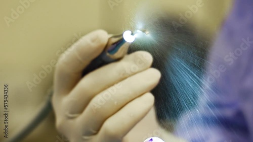 4K close-up footage of pre-ultrasonic piezo rhinoplasty cosmetic surgery. Doctor holding water injecting piezo medical device. Vibration application, sound wave, nose job, medical equipment. 