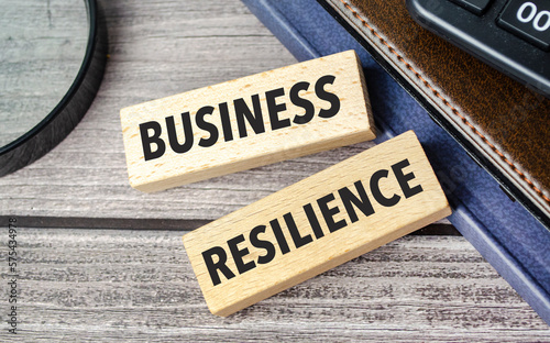 business resilience. text on wooden blocks on wooden background with office supplies