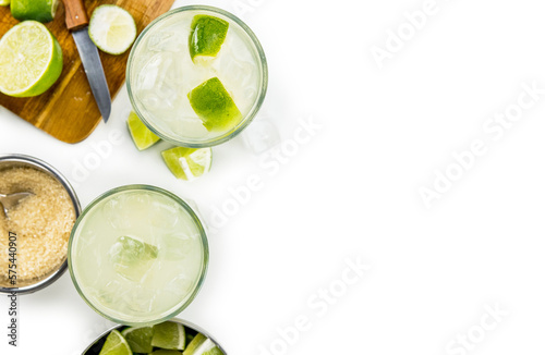 Caipirinha isolated on white background (selective focus; close-up shot)