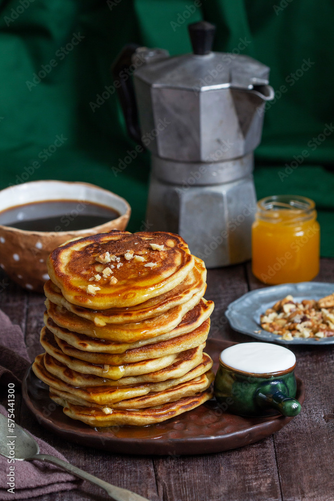 Apple pancakes served with honey, sour cream, nuts, tea and coffee.
