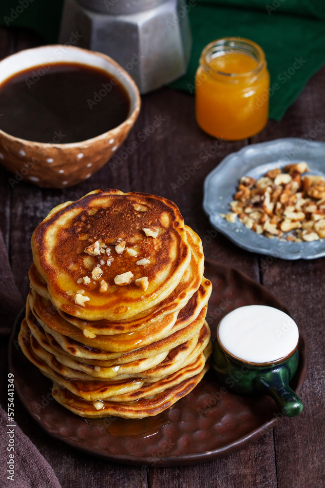 Apple pancakes served with honey, sour cream, nuts, tea and coffee.