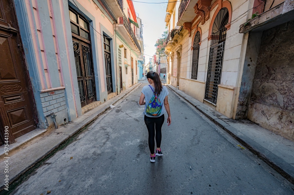 Woman tourist walking through the streets of Old Havana in Cuba.