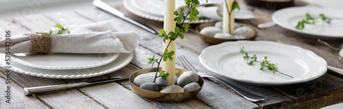 Rustic zero waste wedding decor with natural elements. Wooden table, candles, linen napkins, branches with green leaves. Eco-friendly decoration for the special dinner. Romantic and cozy place. Banner