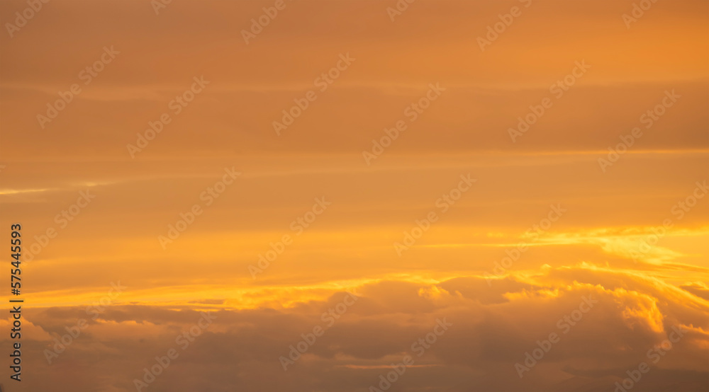 Beautiful bright orange sunset sky with dramatic clouds. Sunset sky background.